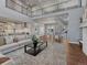 Spacious living area features a large rug, modern furnishings, and an open-concept design leading to the kitchen at 2690 Fox View Trl, Franktown, CO 80116