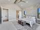 Main bedroom with vaulted ceiling, exposed beam, and a doorway to the ensuite bathroom at 2690 Fox View Trl, Franktown, CO 80116