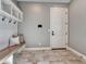 Functional mudroom with built-in bench, coat hooks, and storage, providing a convenient entry space at 2690 Fox View Trl, Franktown, CO 80116