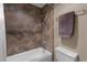 This bathroom features warm brown tiles in the shower and a neutral colored wall at 100 S Park Ave # E321, Breckenridge, CO 80424