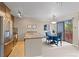 Contemporary kitchen bar and stainless steel appliances are adjacent to dining area with balcony access at 100 S Park Ave # E321, Breckenridge, CO 80424