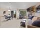 Cozy living room with a stone fireplace, TV, plush sofa, and access to a balcony with outdoor views at 100 S Park Ave # E321, Breckenridge, CO 80424