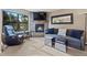 Comfortable living room with a stone fireplace, a flat-screen TV, and views of nature through a large window at 100 S Park Ave # E321, Breckenridge, CO 80424