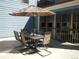 A patio with a large table, seating for six, and an umbrella at 100 S Park Ave # E321, Breckenridge, CO 80424