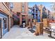Community patio area with outdoor grills, red staircases and brick columns at 100 S Park Ave # E321, Breckenridge, CO 80424