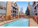 Community pool, with lounge chairs and multi-story buildings surrounding the area at 100 S Park Ave # E321, Breckenridge, CO 80424