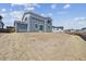 Backyard of a blue two-story home featuring a sodded and graded lot under a blue sky at 9992 Racine St, Commerce City, CO 80022