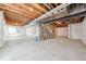 An unfinished basement featuring a concrete floor, exposed beams and ductwork at 9992 Racine St, Commerce City, CO 80022
