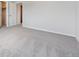 An airy bedroom featuring neutral carpeting, white trim, and a nearby closet at 9992 Racine St, Commerce City, CO 80022
