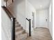 Bright entryway featuring a staircase with black and white railings and luxury vinyl flooring at 9992 Racine St, Commerce City, CO 80022