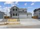 Beautiful two-story home with a three car garage and manicured front yard at 9992 Racine St, Commerce City, CO 80022