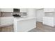 Modern kitchen with white countertops, stainless steel appliances, and gray backsplash at 9992 Racine St, Commerce City, CO 80022