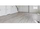 Spacious room with luxury vinyl flooring, neutral walls, and natural light at 9992 Racine St, Commerce City, CO 80022