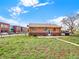 Fenced backyard with ample green space and convenient access, great for Gathering and pets at 6800 Fern Dr, Denver, CO 80221