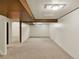 Spacious basement featuring paneled walls, carpet flooring and wood beam accent at 6800 Fern Dr, Denver, CO 80221