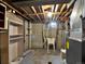 Basement with utilities, concrete floor, concrete walls, and shelving at 6800 Fern Dr, Denver, CO 80221