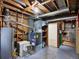 Basement with utilities, concrete floor, exposed ceiling, and shelving at 6800 Fern Dr, Denver, CO 80221