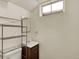 Small powder room featuring compact vanity, toilet, and wire shelving at 6800 Fern Dr, Denver, CO 80221