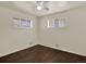 A bright bedroom features hardwood floors, two large windows and neutral walls at 6800 Fern Dr, Denver, CO 80221