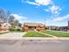 Charming brick home with a well-maintained lawn and a long driveway in a quiet neighborhood at 6800 Fern Dr, Denver, CO 80221