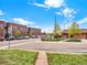 Street view of a brick home, nestled near local buildings and with easy street access at 6800 Fern Dr, Denver, CO 80221
