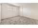 Bright, carpeted bedroom with a white brick accent wall and natural light from a window at 6800 E Tennessee Ave # 111, Denver, CO 80224