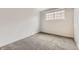 Neutral bedroom with a plush carpet, window bringing in natural light, and a closet at 6800 E Tennessee Ave # 111, Denver, CO 80224