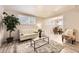 Bright living room features modern decor, neutral tones, and an open layout to the dining area at 6800 E Tennessee Ave # 111, Denver, CO 80224
