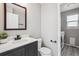 Modern half bath and laundry room featuring sleek fixtures and stylish design at 1551 Northridge Dr, Highlands Ranch, CO 80126