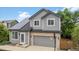 Charming two-story home featuring a grey exterior, solar panels, and a basketball hoop on the driveway at 1551 Northridge Dr, Highlands Ranch, CO 80126