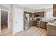 Modern kitchen with stainless steel appliances, granite countertops, wood cabinets, and new wood floors at 1551 Northridge Dr, Highlands Ranch, CO 80126