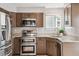 Modern kitchen featuring stainless steel appliances, double oven, granite countertops, and sleek wooden cabinets at 1551 Northridge Dr, Highlands Ranch, CO 80126