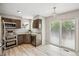 Modern kitchen featuring stainless steel appliances, wood cabinets, granite countertops, and a sliding glass door at 1551 Northridge Dr, Highlands Ranch, CO 80126