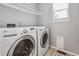 Laundry room has a stacked washer and dryer with a built-in shelf at 1551 Northridge Dr, Highlands Ranch, CO 80126