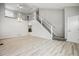 Bright, open-concept living room with soaring ceilings, new floors, and a staircase at 1551 Northridge Dr, Highlands Ranch, CO 80126