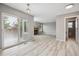 Spacious open-concept living area with a sliding glass door, a fireplace, and wood floors at 1551 Northridge Dr, Highlands Ranch, CO 80126