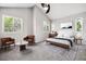 Sunlit bedroom with vaulted ceilings, neutral carpet, and tasteful decor at 1551 Northridge Dr, Highlands Ranch, CO 80126