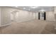 Open finished basement with neutral carpet, recessed lighting, and access to other rooms at 23420 E Berry Ave, Aurora, CO 80016