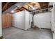 Unfinished basement with concrete floor and exposed ceiling offering potential for customization at 23420 E Berry Ave, Aurora, CO 80016