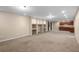 Basement features neutral carpet, recessed lighting, built-in shelves, and kitchenette at 23420 E Berry Ave, Aurora, CO 80016