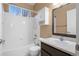 Bathroom features a shower over tub, white vanity, and window providing natural light at 23420 E Berry Ave, Aurora, CO 80016