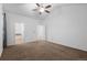 Spacious bedroom with en-suite bathroom access and neutral carpeting at 23420 E Berry Ave, Aurora, CO 80016