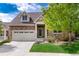 Charming two-story home with a stone facade, attached garage, and well-maintained landscaping at 23420 E Berry Ave, Aurora, CO 80016