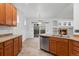 Bright kitchen with stainless steel appliances, tile floors, and sliding glass doors to the backyard at 23420 E Berry Ave, Aurora, CO 80016