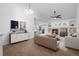Bright living room with fireplace, built-in shelving, neutral decor, and modern furnishings at 23420 E Berry Ave, Aurora, CO 80016