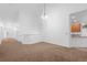 Spacious living room with vaulted ceiling, neutral paint, carpet, and ample natural light at 23420 E Berry Ave, Aurora, CO 80016