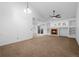 Open-concept living room featuring a fireplace, built-in shelves, and a sliding glass door at 23420 E Berry Ave, Aurora, CO 80016
