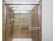 Modern tile shower with sleek glass door and updated fixtures at 23420 E Berry Ave, Aurora, CO 80016