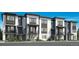 Modern townhome showcasing a sleek, contemporary design with multiple units and well-manicured landscaping at 646 Saddle Dr, Erie, CO 80516