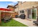 Private backyard with seating area, grill, and sliding glass door access to the home at 1264 S Crystal Way, Aurora, CO 80012